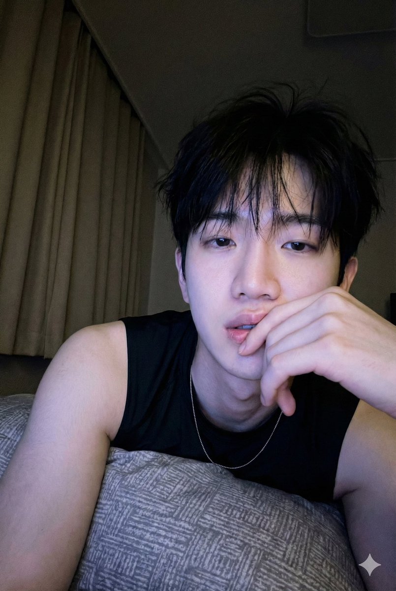 Vertical frame, realistic low-light phone selfie, in a dark night bedroom, face identical to the...